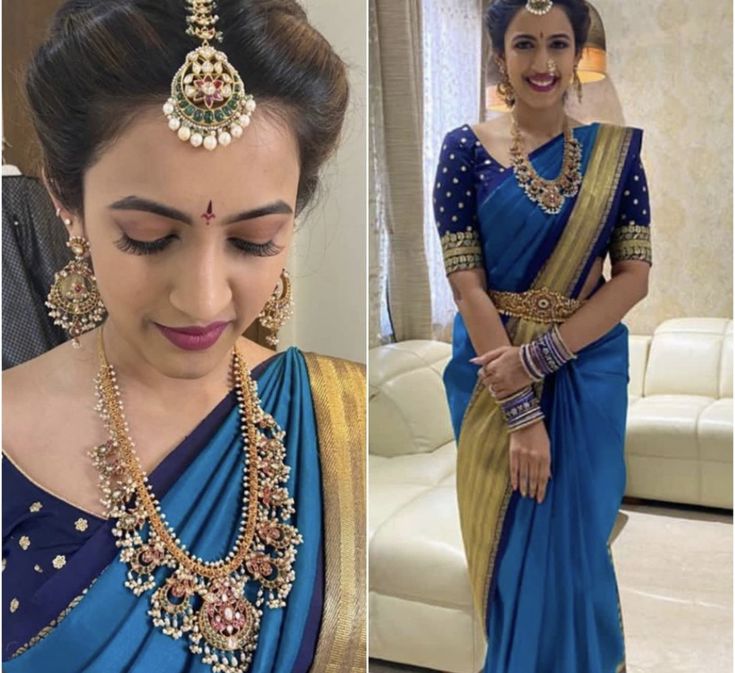 a woman wearing a blue and gold sari with jewelry on her neck, standing in front of a white couch