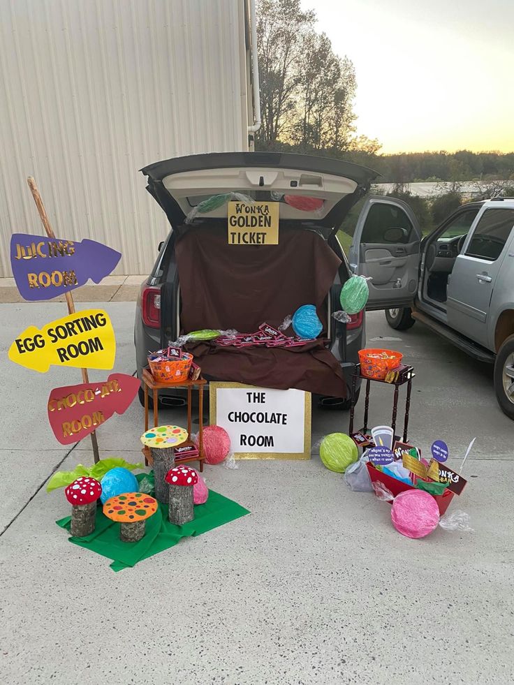 the trunk of a car is open with decorations and signs in front of it,