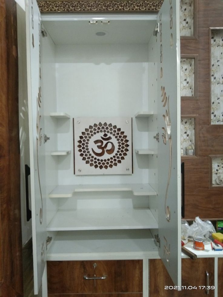 the inside of a white cabinet with an omesh symbol painted on it