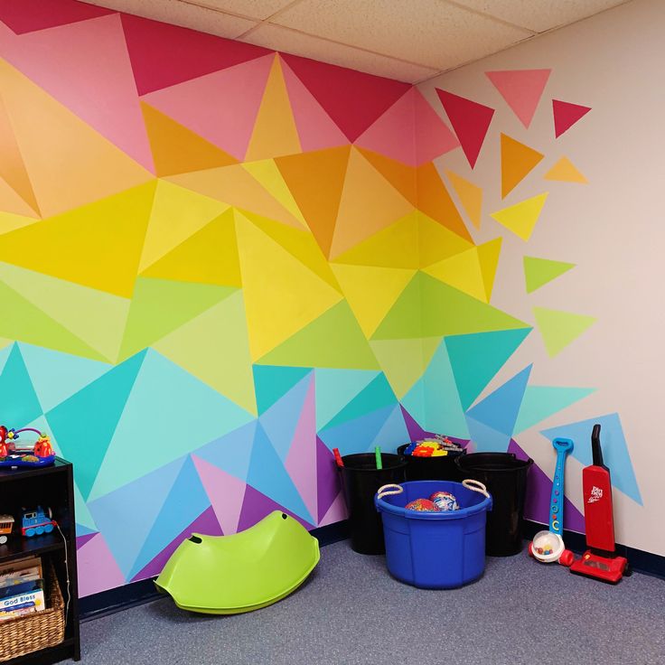 a room with colorful walls and toys on the floor