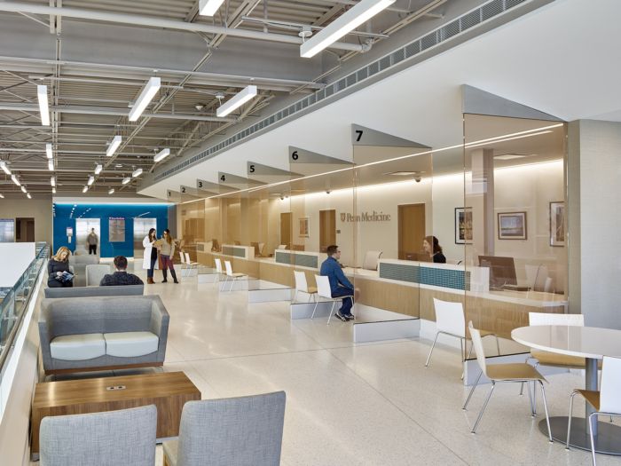 an office lobby with people sitting at desks