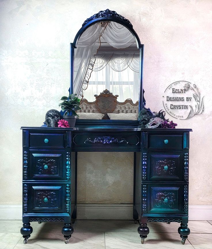 an ornate black desk with mirror and drawers