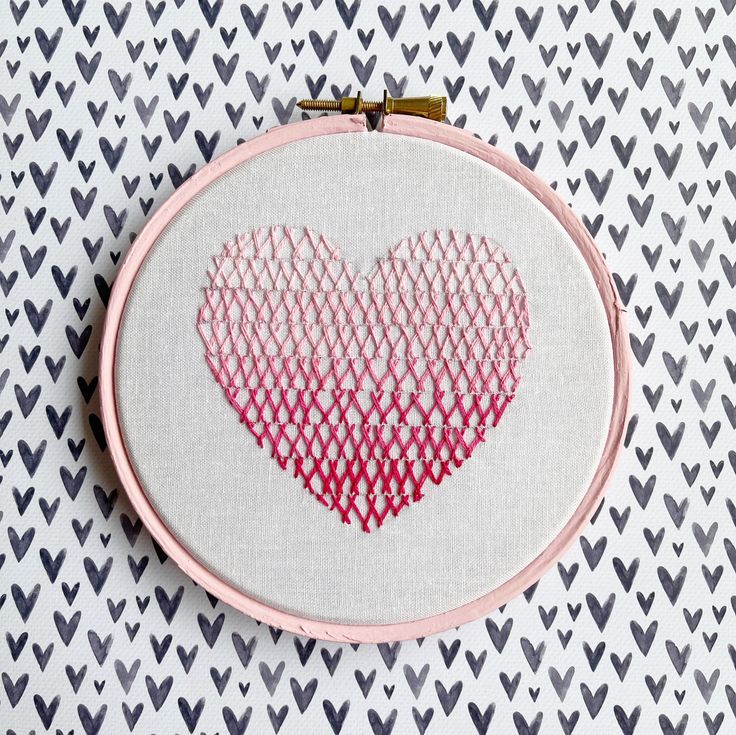 a heart is shown in the middle of a cross stitch pattern