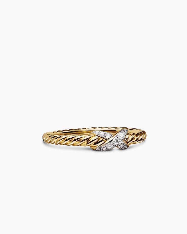 a gold ring with two diamonds on it