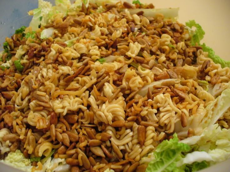 a salad with nuts and lettuce in it