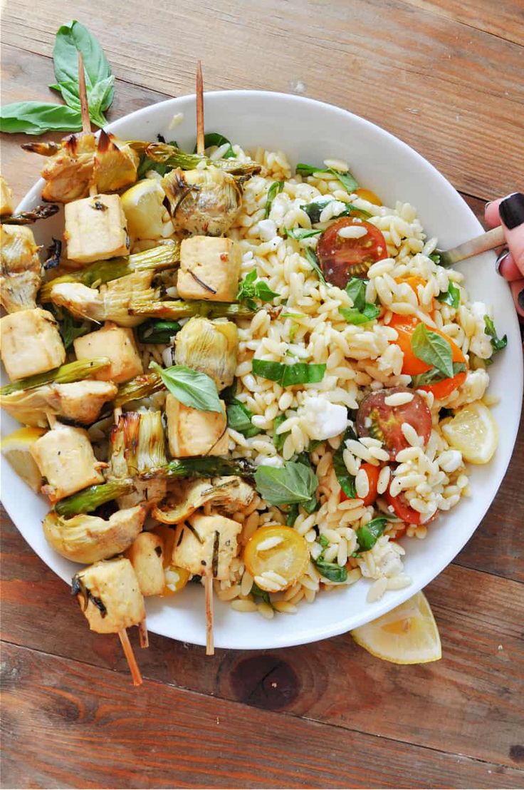 vegan spring lemon veggie and tofu skewers on a white plate