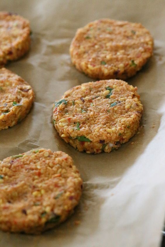 six cookies sitting on top of a piece of wax paper