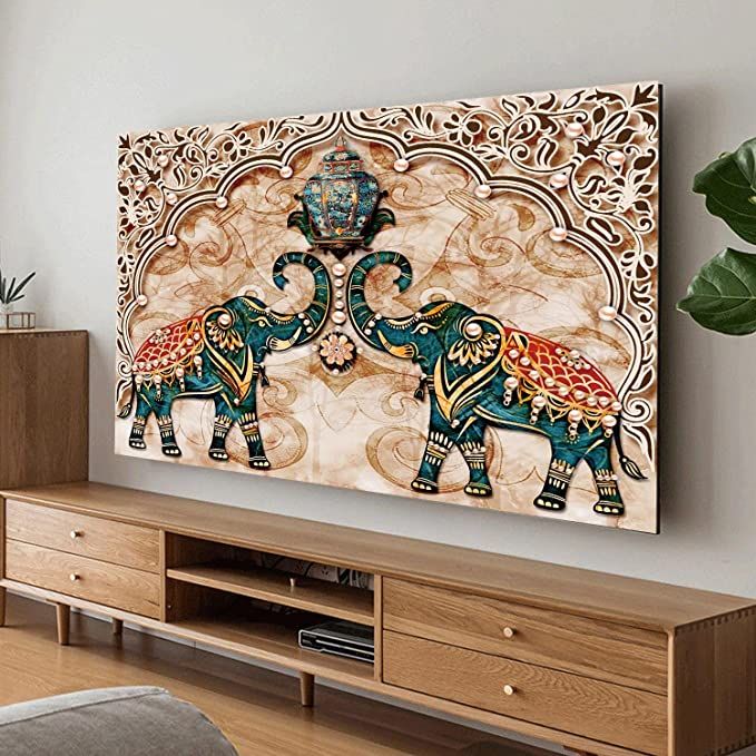 an elephant painting is hanging on the wall above a wooden entertainment center in a living room