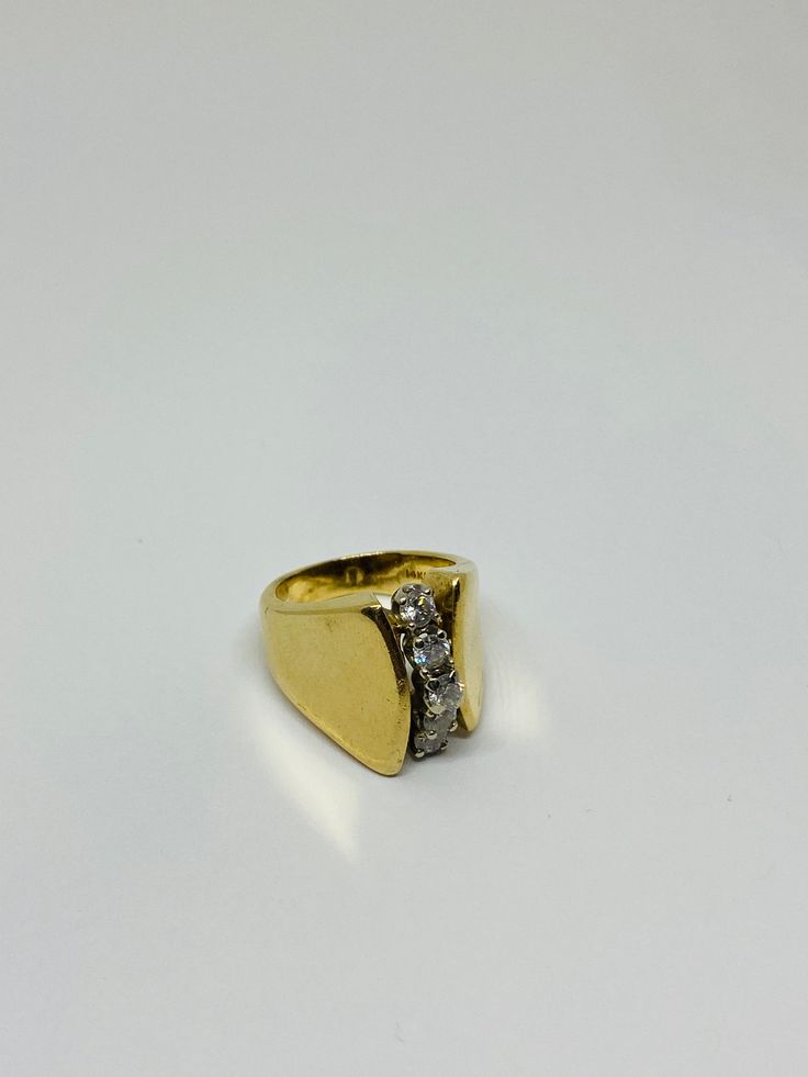 "This is a 14K yellow gold and diamond statement ring. Material(s): 14K yellow gold + (5) diamonds 0.05 of a carat each (This ring is 0.25, or 1/4, of a carat total weight) Total weight: 8.2 grams Flaws (if any): None to mention Marking(s): \"585\" (translating to \"14K\") Size: This ring is a band size 7 U.S. Measurements: The face of this statement ring measures 7.5 millimeters. If you have any questions about this ring, please do not hesitate to contact us! ♥" Diamond Signet Ring With 17 Jewels For Anniversary, Formal Gold Wide Band Ring With Single Cut Diamonds, Classic Wide Band Ring With Single Cut Diamonds, Antique Gold Diamond Ring With Vvs Clarity, Vintage Yellow Gold Diamond Signet Ring, Vintage Yellow Gold Signet Ring With Diamonds, Gold Wide Band Ring With Vvs Clarity, Classic Diamond Wide Band Ring For Anniversary, Vintage Yellow Gold Rings With Diamond Accents