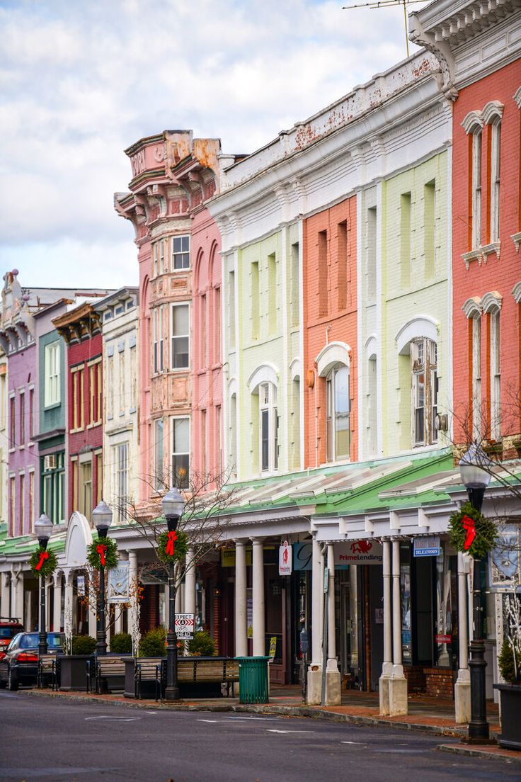 a row of multi - colored buildings on a city street