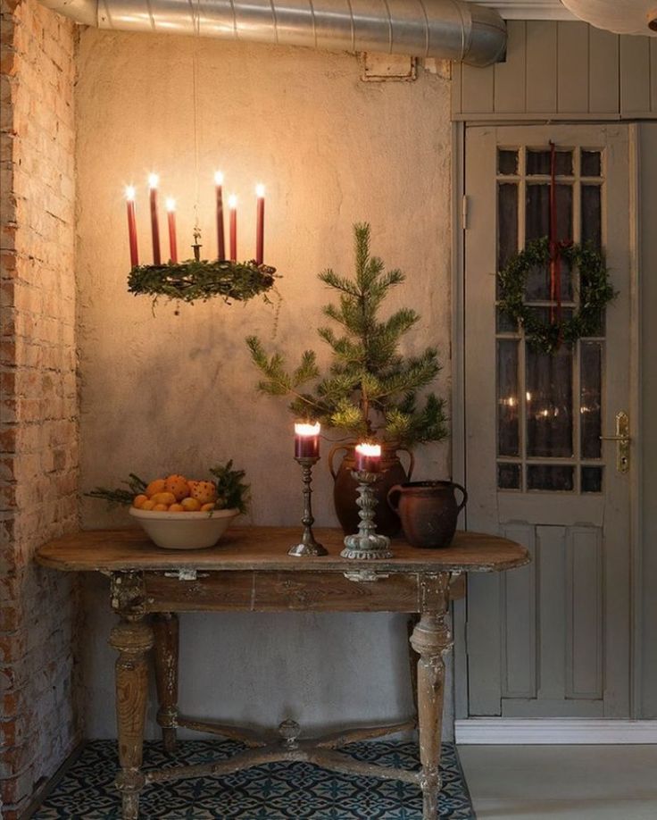 a table with candles on it in front of a door