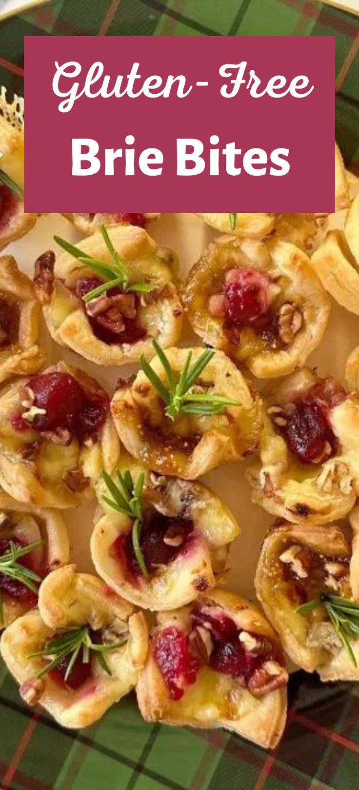 a plate filled with mini brie bites covered in cranberry sauce and rosemary