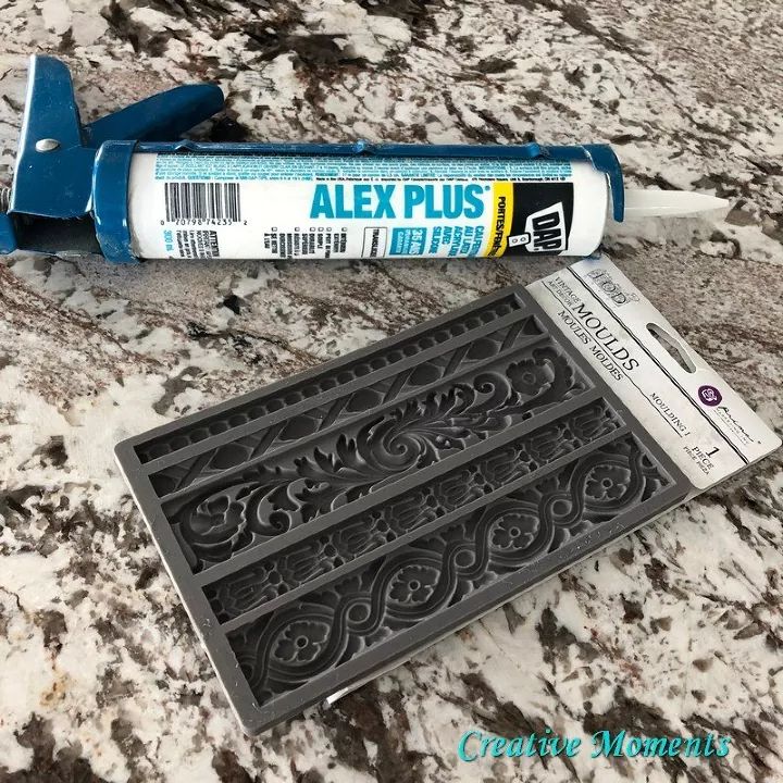 the glue is next to an old metal grate and it has been placed on a marble surface