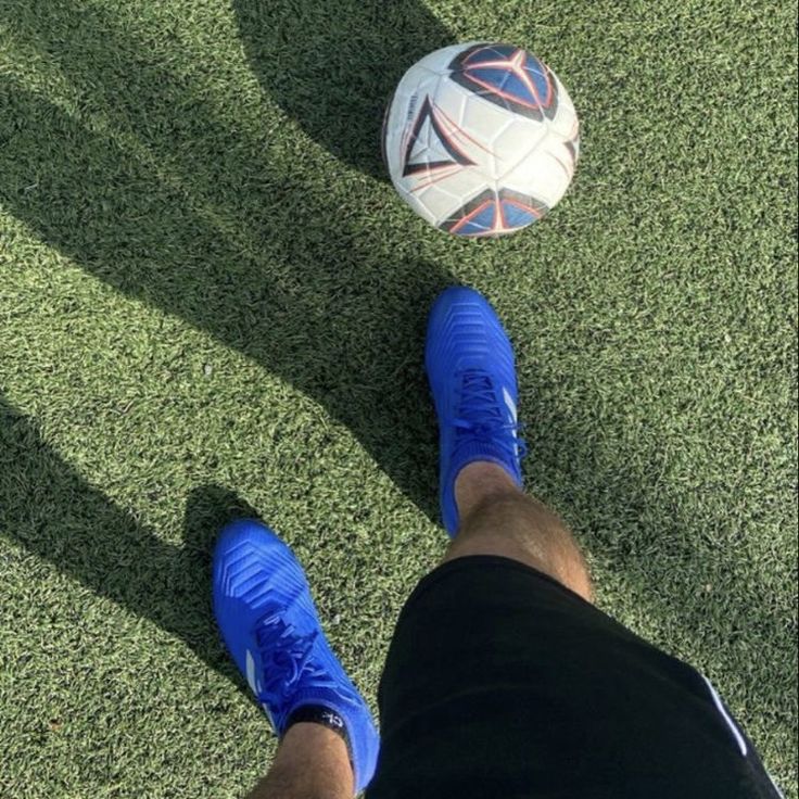 a person standing next to a soccer ball