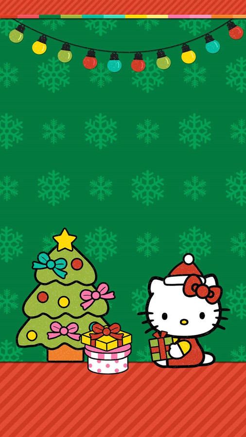 the hello kitty christmas tree is next to a green wall with snowflakes on it