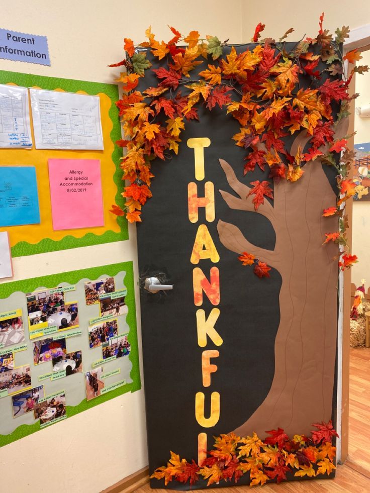 a door decorated with leaves and the word thank you written on it is in front of a bulletin board