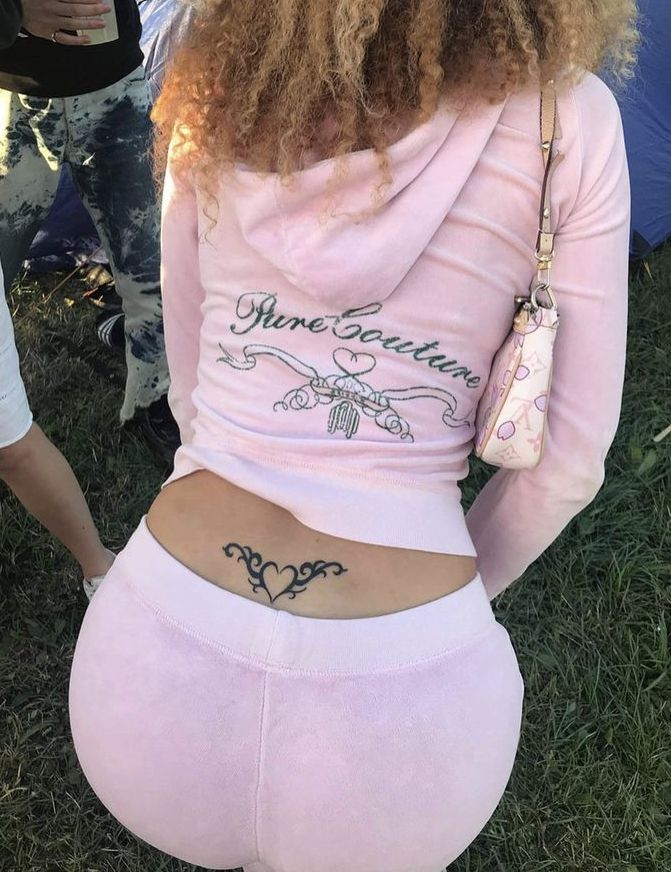 the back of a woman's pink sweatpants with an embroidered name on it