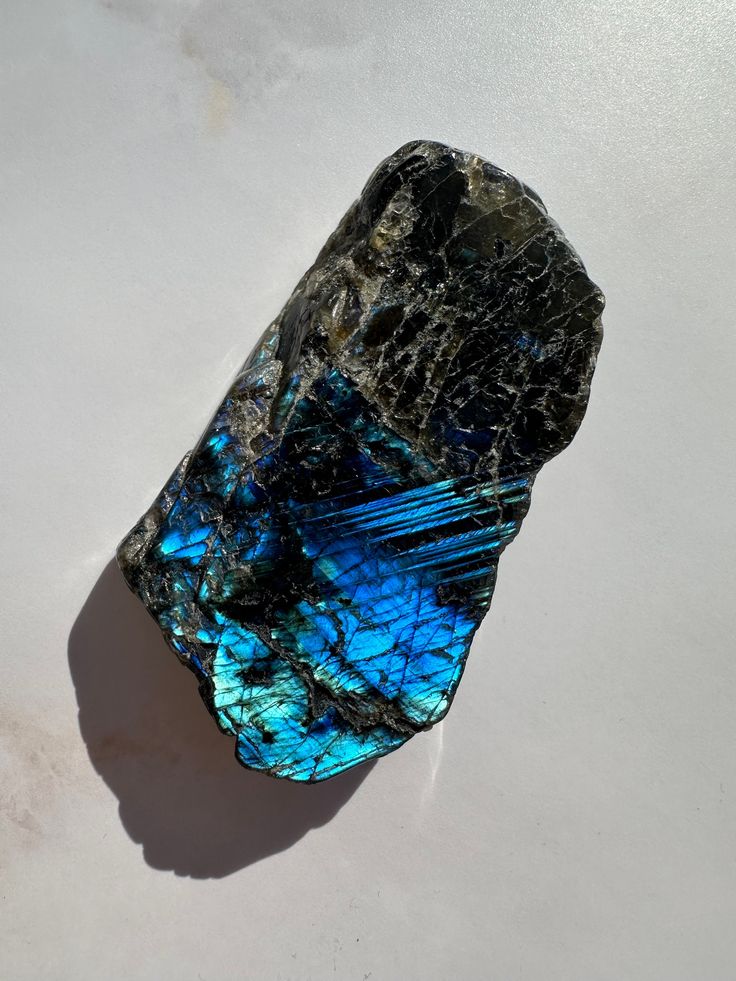 a blue and black rock sitting on top of a white table