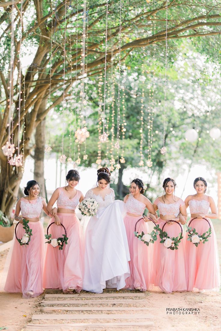 the bridesmaids are all dressed in pink dresses