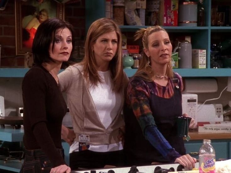 three women standing in front of a counter