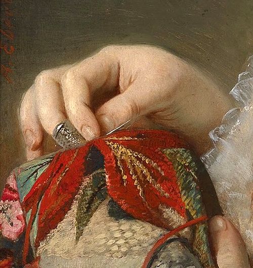 a close up of a person sewing on a piece of cloth