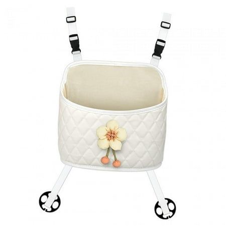 an image of a baby crib with wheels and flowers on the handlebars