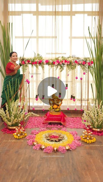 a woman sitting on top of a wooden floor in front of flowers and greenery