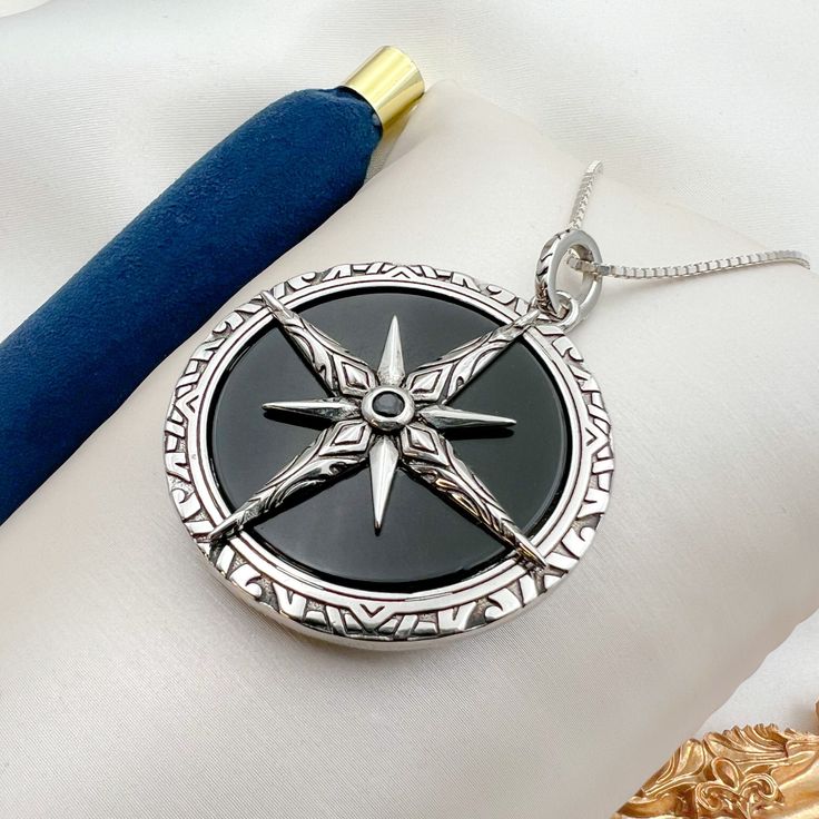 Handcrafted Artisan Pendant: Large Star of Bethlehem/North with Black Onyx Stone in 925 Silver + Chain Included - 1.50"x1.50" 🛠️ Exquisite Craftsmanship: This stunning pendant is meticulously handcrafted by skilled artisans, ensuring each piece is unique and of the highest quality. Made from genuine 925 silver, the pendant features a large, flat, round black onyx stone that radiates elegance and timeless beauty. ⭐ Symbolic Design: The Star of Bethlehem, also known as the Star of the North, is a Black Star-shaped Sterling Silver Necklace, Symbolic Black Star Of David Jewelry, Black Compass Design Jewelry Gift, Black Amulet Locket Jewelry, Black Sterling Silver Medallion Jewelry, Silver Medallion Necklace With Black Enamel, Black Sterling Silver Amulet Necklace, Black Star Of David Necklace, Spiritual Style, Black Star-shaped Spiritual Jewelry