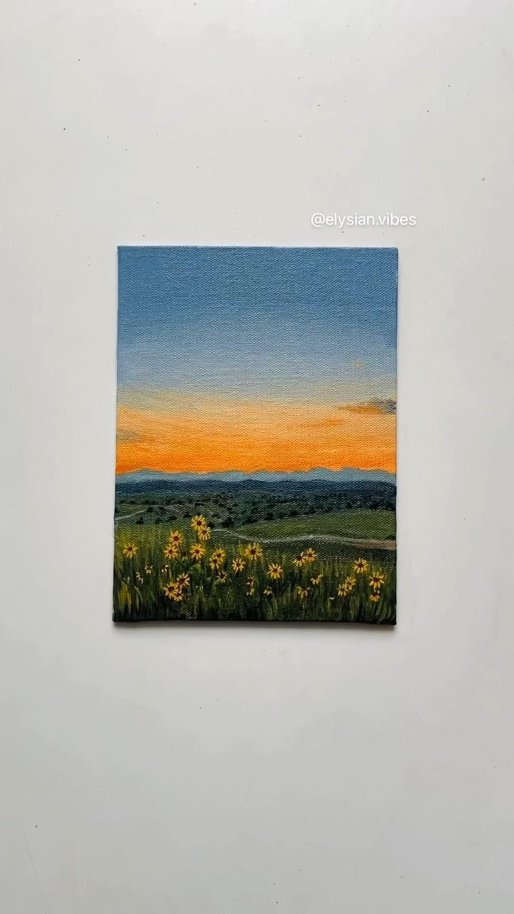 the painting is hanging on the wall in front of the white wall and it has sunflowers