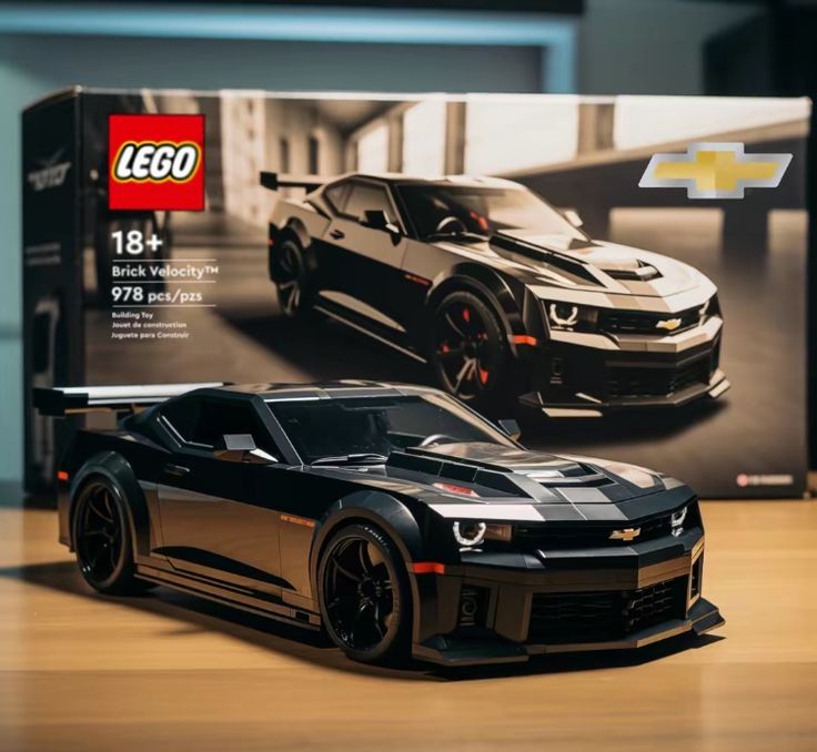 a black chevrolet camaro is on display in front of a lego box with the image of a car