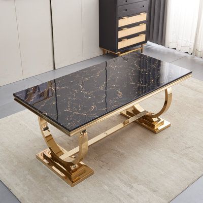 a black and gold coffee table with drawers