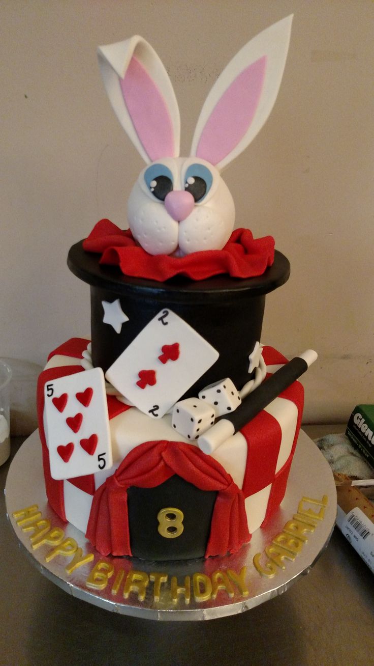 a birthday cake made to look like a rabbit sitting in a magician's hat