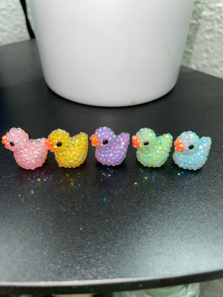 five little birds are lined up on a table