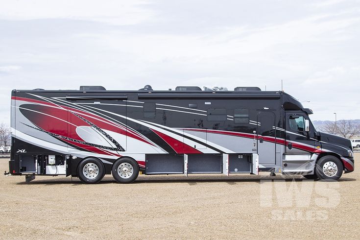 a black and red bus parked in a parking lot