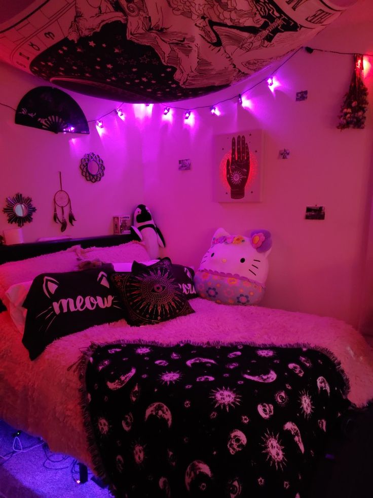 a bedroom with pink lights and hello kitty bedding