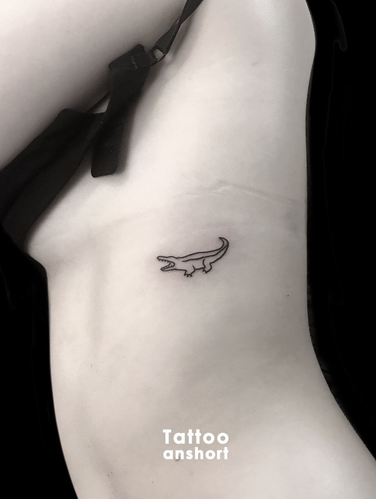 a woman's stomach with a small tattoo on the left side of her body