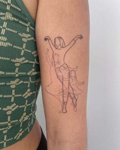 a woman's arm with a drawing of a ballerina on the left side