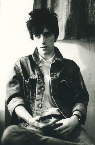 black and white photograph of a young man sitting down