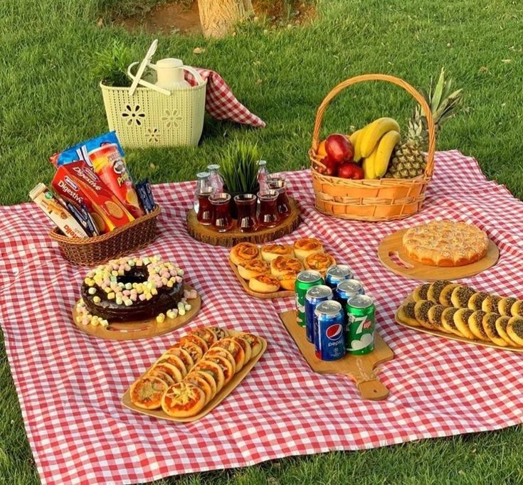 a picnic blanket with food and drinks on it