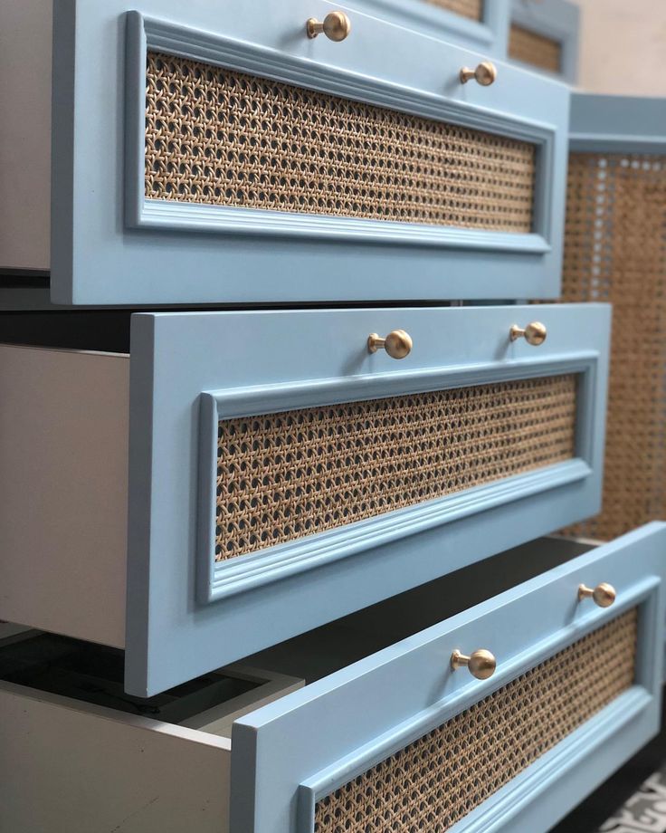 two blue drawers with wicker handles on each drawer