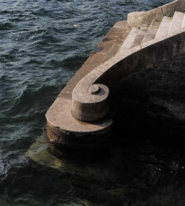 the concrete steps lead down to the water