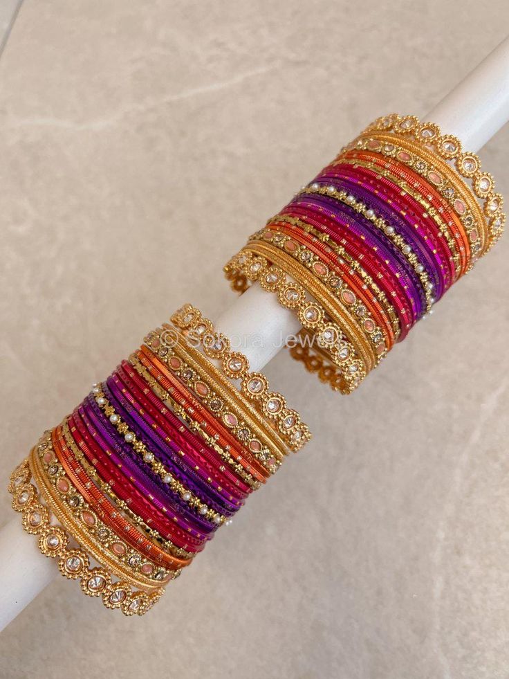 Large stack of Bright gold, purple, pink and orange bangle set with golden zircon kada bangles on the ends. Ready to Ship! Orange Bangles Set, Bangle Set Pink, Bangles Combination, Kada Bangles, Beautiful Bangles, Unique Mehndi, Colorful Bangles, Bangle Box, Purple Sunset