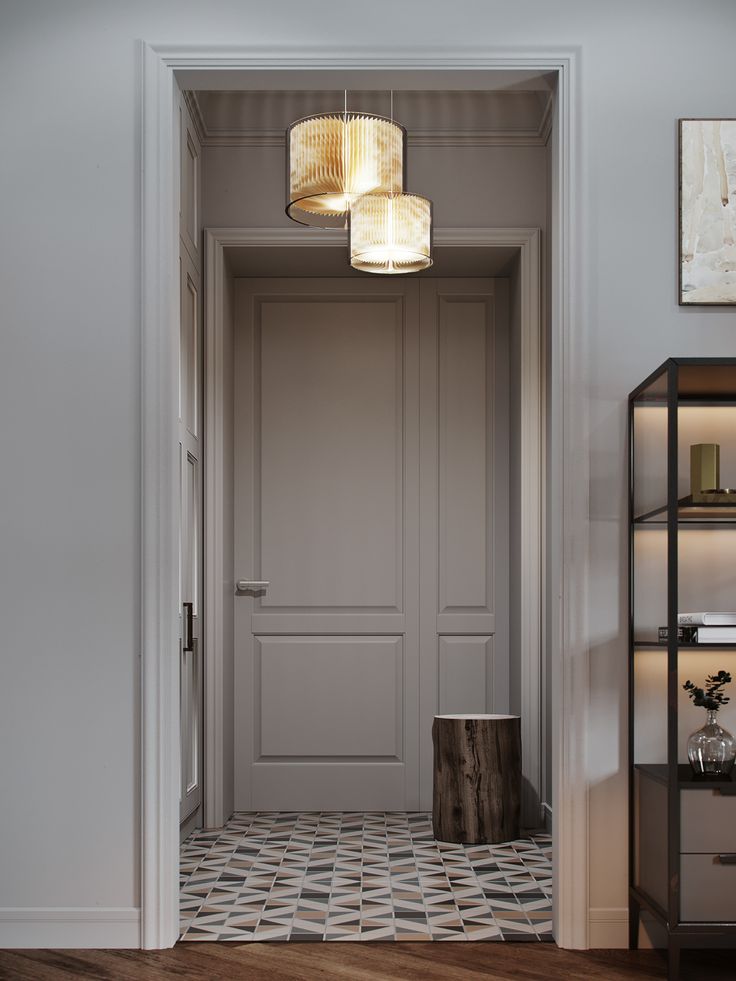 an open door leading into a room with white walls and wooden floors, two lamps hanging from the ceiling