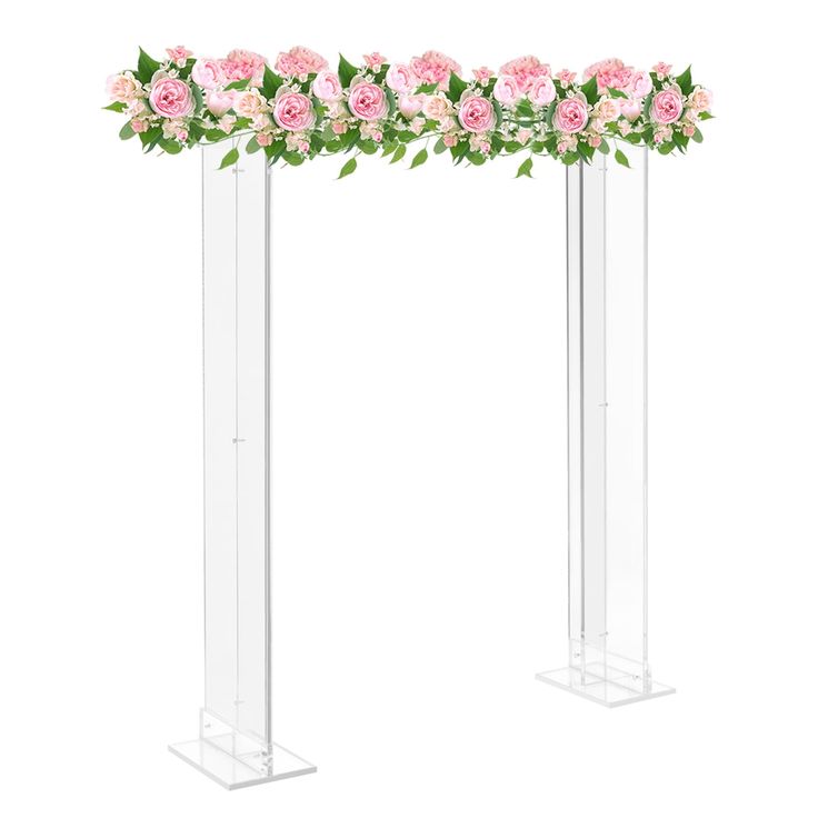 two tall clear vases with pink flowers and greenery on the top one is empty