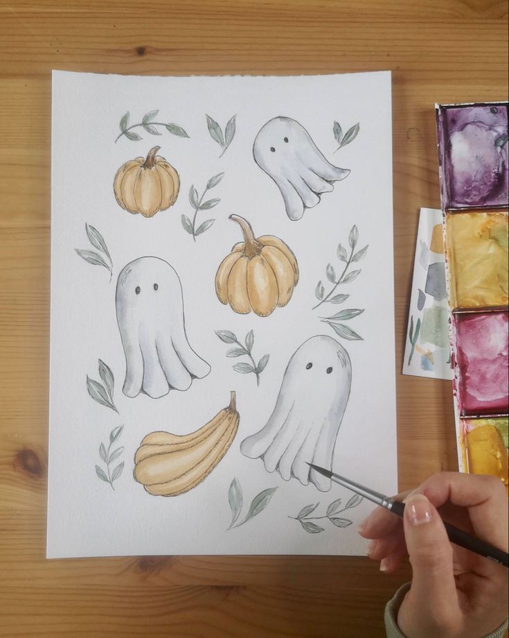 someone is painting an image with watercolors on paper