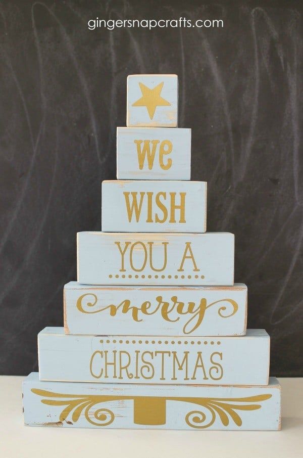 we wish you a merry christmas wood block sign with gold lettering on it and a star