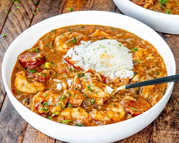 two white bowls filled with shrimp and rice