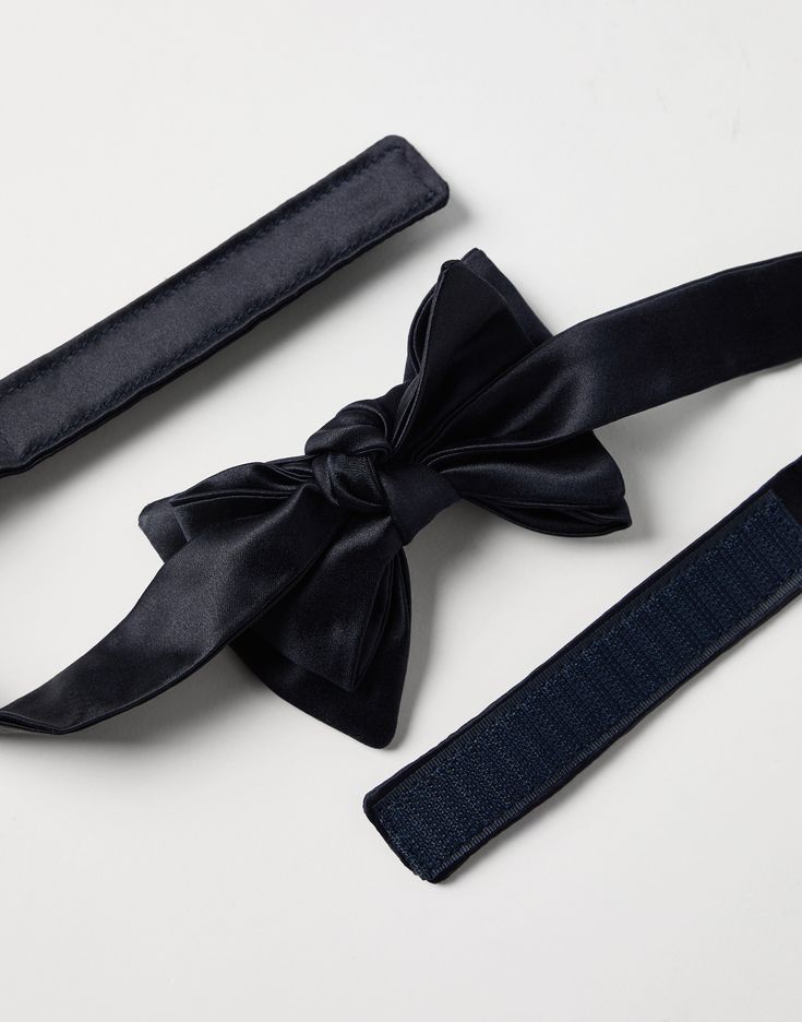 Cotton and silk satin bow tie An essential accessory for evening events, the cotton and silk satin bow tie completes tuxedos with classic flair. This accessory, which must be tied, is adjustable thanks to a convenient hook-and-loop closure behind the neck. Pre-tied Satin Bow For Black Tie Events, Satin Bow Ties For Parties, Satin Bow Ties For Party, Formal Silk Decorative Bow, Formal Silk Satin Bow, Elegant Pre-tied Satin Bow, Satin Bow For Black-tie Events, Chic Detachable Bow Tie For Black Tie Events, Satin Standard Tie Bow For Parties