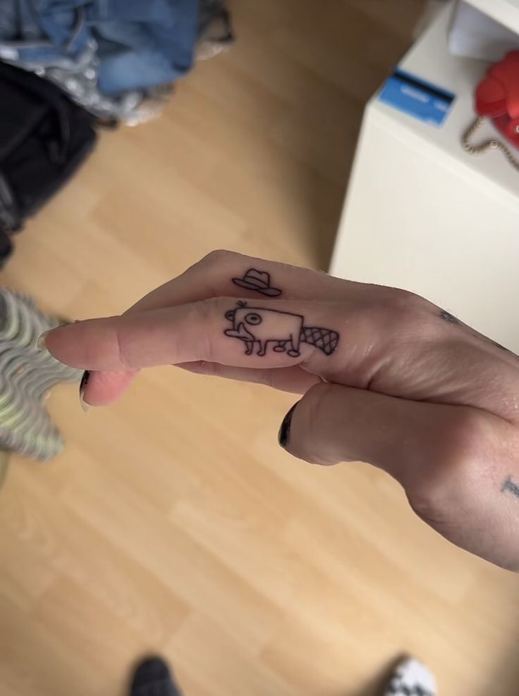 a person with a small tattoo on their finger