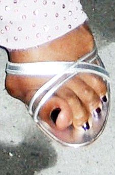 a woman's foot wearing silver sandals